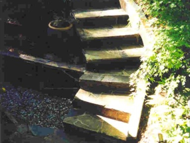 125 80 lb. bags of concrete in the stairway and retaining wall to left. Then it was all covered in Mariposa slate.   Kings Mountain