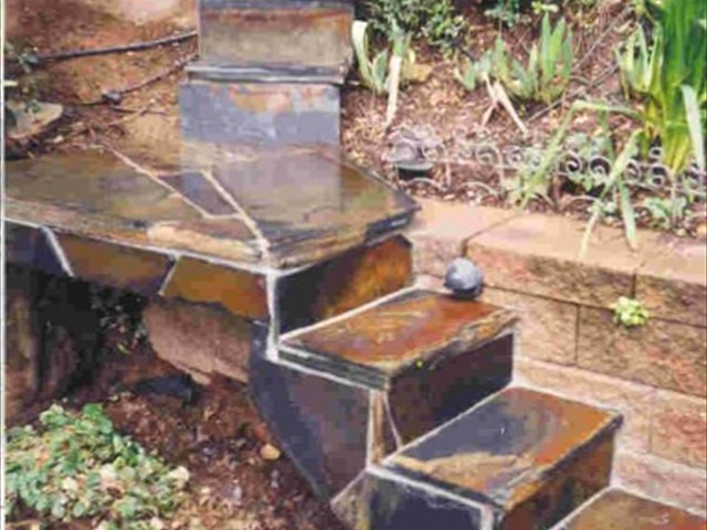 125 80 lb. bags of concrete in the stairway and retaining wall to left. Then it was all covered in Mariposa slate.   Kings Mountain5